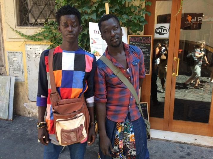 Mbaye Diope (left) and Mornyang (right), both from Senegal, searching for better lives in Rome, Italy [photo by – Eric Kafui Okyerefo]